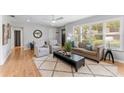 Bright living room with hardwood floors, neutral paint, large windows, and modern furnishings at 3125 W Fielder St, Tampa, FL 33611
