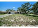 Inviting single-story home with an attached garage and a traditional, well-manicured lawn at 3305 Blythe Ave, Spring Hill, FL 34609