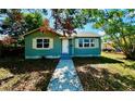 Inviting single-story home with walkway, complemented by lush greenery at 4214 Fairfield S Ave, St Petersburg, FL 33711