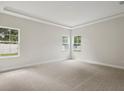This bedroom with neutral carpet features lots of natural light from the large windows at 4523 Foley Grove Dr, Valrico, FL 33596