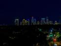 Nighttime skyline view with vibrant city lights and lush greenery below, a captivating urban panorama at 4651 1St Ne St # 402, St Petersburg, FL 33703