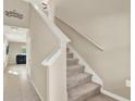 Interior staircase with carpeted steps and white railing leading to the second floor at 5067 Sable Chime Dr, Wimauma, FL 33598