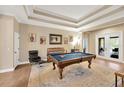 Spacious game room featuring a pool table, coffered ceiling, and access to outdoor area at 5825 Terncrest Dr, Lithia, FL 33547