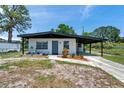Charming single-story home featuring a covered carport, landscaping, and a well-maintained front yard at 6507 La Mesa Cir, Tampa, FL 33634
