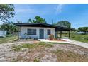 Charming single-story home featuring a covered carport and a well-maintained front lawn at 6507 La Mesa Cir, Tampa, FL 33634