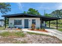 Charming single-story home featuring a covered carport and a well-maintained front yard at 6507 La Mesa Cir, Tampa, FL 33634