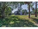 Charming two-story home with ample front lawn and mature trees providing shade at 6521 Oelsner St, New Port Richey, FL 34652