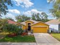 Charming one-story home features a two-car garage and beautifully landscaped front yard at 6914 Monarch Park Dr, Apollo Beach, FL 33572