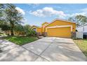 Charming one-story home features a two-car garage and beautifully landscaped front yard at 6914 Monarch Park Dr, Apollo Beach, FL 33572