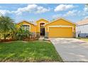 Charming one-story home features a two-car garage and beautifully landscaped front yard at 6914 Monarch Park Dr, Apollo Beach, FL 33572