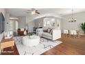 A spacious living room with hardwood floors and lots of natural light, virtually staged with modern furniture at 9329 Huntington Park Way, Tampa, FL 33647