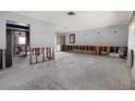 Wide-open space with partial view of kitchen, ready for custom flooring and renovations at 11628 Grove St, Seminole, FL 33772