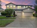 Charming two-story home with landscaped yard and a large two car garage and wide driveway at 11706 Gilmerton Dr, Riverview, FL 33579