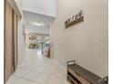 Bright foyer with tile flooring, bench and coat rack at 11706 Gilmerton Dr, Riverview, FL 33579