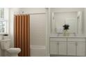 Bright bathroom with subway tile, double sink vanity, and a shower with a curtain and modern fixtures at 11761 E 71St Ter, Palmetto, FL 34221