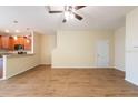 Open-concept living room with modern flooring, ceiling fan, and an eat-in kitchen at 11903 Greengate Dr, Hudson, FL 34669
