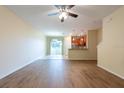 Spacious living room features hard wood floors, neutral walls, and a sliding glass door at 11903 Greengate Dr, Hudson, FL 34669