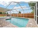 Inviting in-ground pool area, perfect for relaxation and outdoor entertaining in a private, screened enclosure at 12279 Elmore Dr, Spring Hill, FL 34609