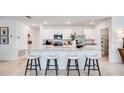 Modern kitchen featuring an island with bar seating, stainless steel appliances, and ample cabinet space at 13570 Tropical Breeze Way, Hudson, FL 34669