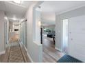 Inviting entryway showcasing wood floors, sliding closet doors, and seamlessly flowing into the living area at 14204 Yacht Club Blvd, Seminole, FL 33776