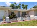 Inviting front porch with a white lattice fence and seating area, offering a cozy outdoor space at 1445 Wilson Rd, Clearwater, FL 33755