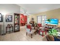 Spacious living room with tile floors, accented by brick and colorful walls, with lots of decor at 1445 Wilson Rd, Clearwater, FL 33755