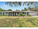Charming single-story home featuring a well-maintained lawn at 1607 Melodie Dr, Brandon, FL 33510