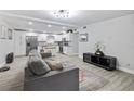 Open-concept living room featuring an integrated kitchen and a comfortable couch to create a relaxed environment at 2002 Waikiki Way, Tampa, FL 33619