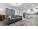 Inviting living room featuring a cozy couch and open view of the kitchen to create a welcoming atmosphere at 2002 Waikiki Way, Tampa, FL 33619