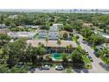 Aerial view of property featuring lush landscaping, pool, and neighborhood setting at 208 Danube Ave # 101, Tampa, FL 33606