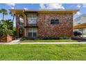 Charming brick apartment building with a landscaped lawn, covered parking, and access to Davis Islands at 208 Danube Ave # 101, Tampa, FL 33606
