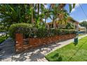 Lush landscaping and well-maintained brick exterior enhance curb appeal at 208 Danube Ave # 101, Tampa, FL 33606