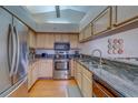 Bright kitchen with stainless steel appliances and granite countertops at 2749 Countryside Blvd # 4, Clearwater, FL 33761