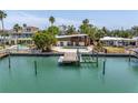 Beautiful waterfront home boasts private dock, boat lift, and scenic views of the tranquil bay at 31 Dolphin Dr, Treasure Island, FL 33706