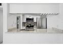 Kitchen with stainless steel appliances, granite counters, and white cabinets at 3102 W Horatio St # 13, Tampa, FL 33609