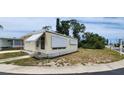 This cozy home boasts a sunny disposition with its light yellow siding and mature landscaping at 3301 Alt 19 # 500, Palm Harbor, FL 34683