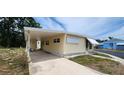 Well-maintained single-story home with covered parking and manicured landscaping at 3301 Alt 19 # 500, Palm Harbor, FL 34683