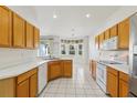 Eat-in kitchen with white appliances, light wood cabinets, and bright natural light at 3311 Stonebridge Trl, Valrico, FL 33596