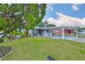 Charming single-story home with a carport and well-maintained front lawn at 3411 W Beach St, Tampa, FL 33607