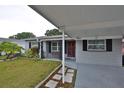 Charming single-story home with a carport and manicured lawn at 3411 W Beach St, Tampa, FL 33607