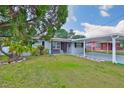 Charming single-story home with a carport and well-maintained front lawn at 3411 W Beach St, Tampa, FL 33607