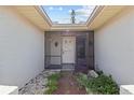 Inviting screened entryway featuring decorative tile and a front door with sidelights at 4274 Deleon Dr, Hernando Beach, FL 34607