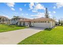 Charming single-story home with a red tile roof and an attached two-car garage at 4274 Deleon Dr, Hernando Beach, FL 34607