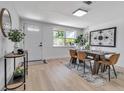 Light-filled dining area with light wood floors, table with tan chairs, and decorative accents at 4624 83Rd Terrace N, Pinellas Park, FL 33781