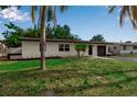 Single-story home with well-maintained lawn and landscaping, plus fresh exterior paint and a dark driveway at 4624 83Rd Terrace N, Pinellas Park, FL 33781