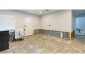 Spacious room awaiting remodel with white walls, recessed lighting, and new back door at 4714 W Lawn Ave, Tampa, FL 33611
