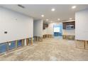 Open-concept room awaiting remodel with white walls, recessed lighting, and bar at 4714 W Lawn Ave, Tampa, FL 33611