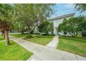 Attractive home exterior with lush landscaping, a paver walkway, and a charming architectural style at 5015 S Elberon St, Tampa, FL 33611