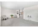 Bright living room with plush carpeting, neutral walls, and modern decor at 5213 Burr Pl, Seffner, FL 33584