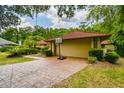 Attached two car garage with a red-tiled roof and a convenient basketball hoop on the driveway at 5702 Ainsworth W Ct, Tampa, FL 33647